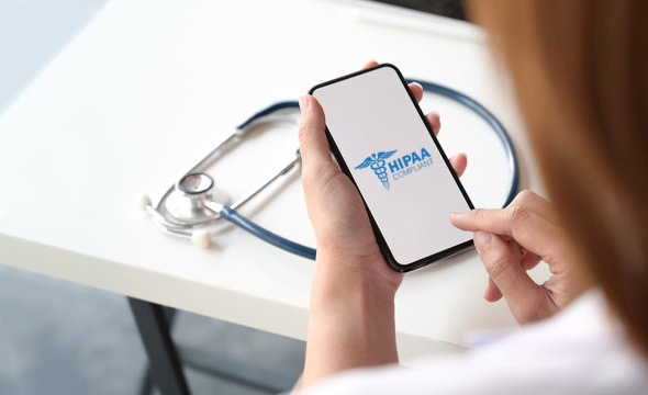 Woman in healthcare field opening HIPAA app on her phone
